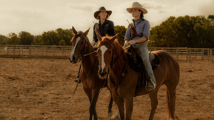 Anna Torv and Philippa Northeast in Territory ride horses.