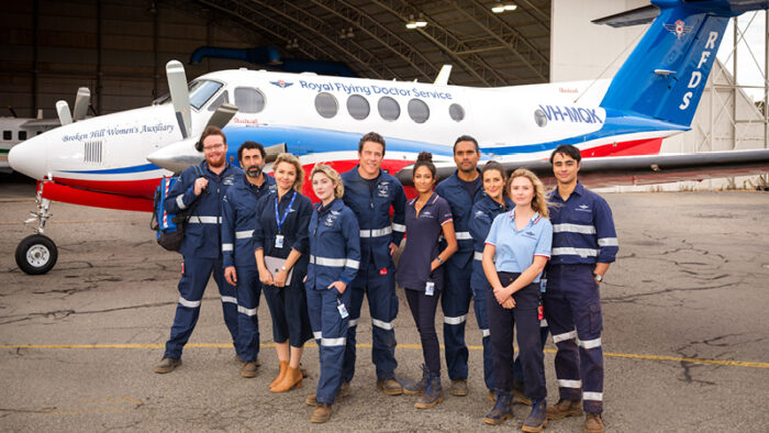 RFDS cast in front of a Royal Flying Doctor Service plane