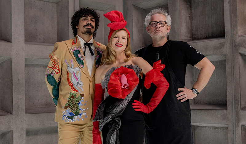 Tony Armstrong, Kirsha Kaechele and Vince Trim stand in front of a grey concrete wall.