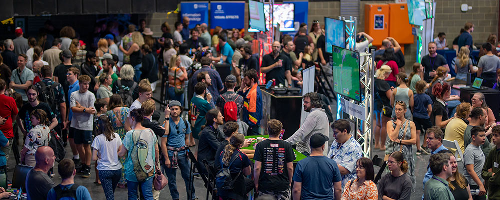 A crowd of people enjoy playing and watching video games at SAGE 2025.