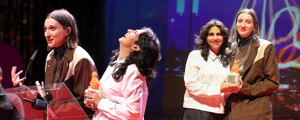 Two side by side images: in one, Emma Hough Hobbs speaks into a lectern while receiving the Teddy Award as Leela Varghese laughs, in the other Leela and Emma pose together with the Teddy Award.